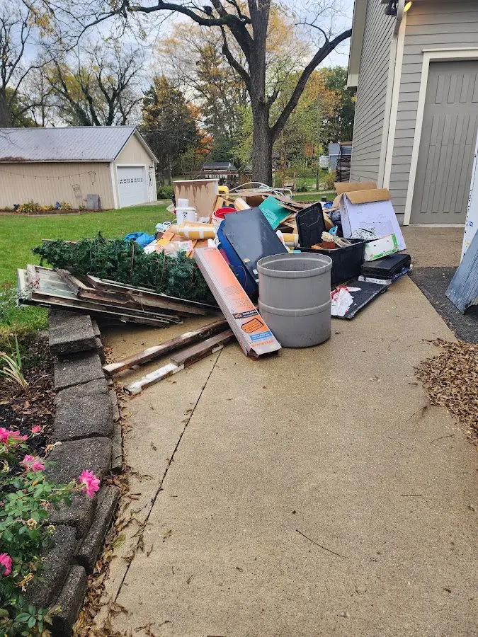Dumpster being loaded with debris for 12 Yard Dumpster Rental in Broadway